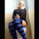 A blonde, European girl wearing glasses sits down on a toilet, smokes a cigarette, pisses and wipes herself. Peeing only. Vertical format video. Over 5 minutes.
